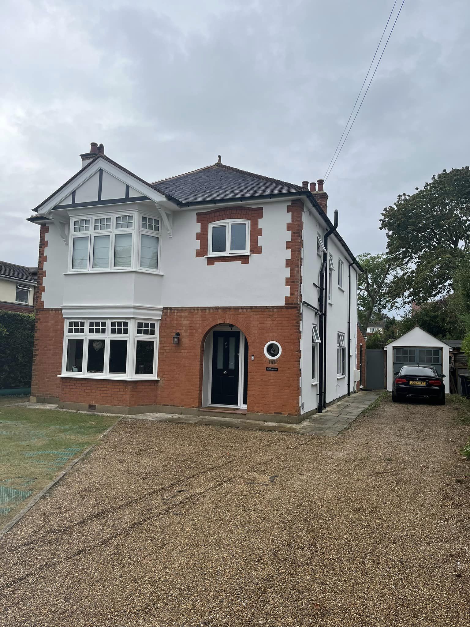 Detached house in Wetherby with white rendered upper walls and retained red-brick architectural details.